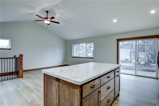 1319 Carli Ct Lot 80, Chippewa Falls, WI 54729 - kitchen featuring a ceiling fan, light wood finished floors, lofted ceiling, light countertops, and a center island