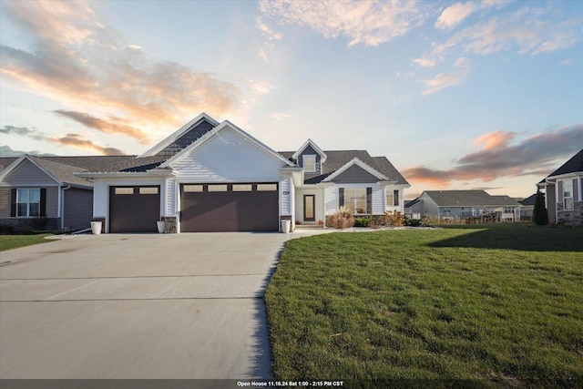 view of front facade featuring a garage and a lawn