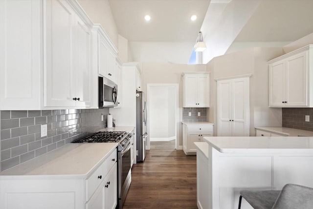 7759 Sunstone Ct, De Pere, WI 54115 - kitchen featuring appliances with stainless steel finishes, decorative backsplash, white cabinetry, dark wood-type flooring, and recessed lighting