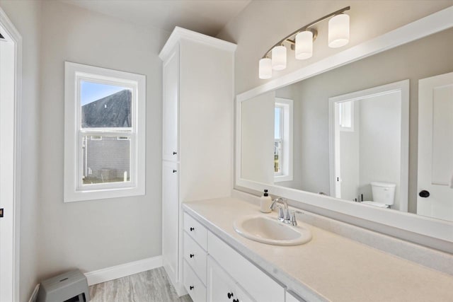 7759 Sunstone Ct, De Pere, WI 54115 - bathroom with vanity, toilet, baseboards, and wood finished floors