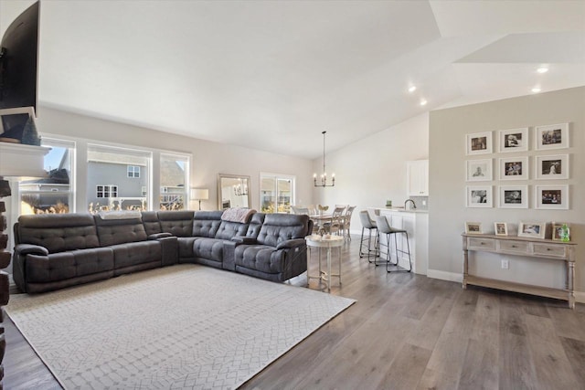 7759 Sunstone Ct, De Pere, WI 54115 - living area with a chandelier, wood finished floors, high vaulted ceiling, and recessed lighting