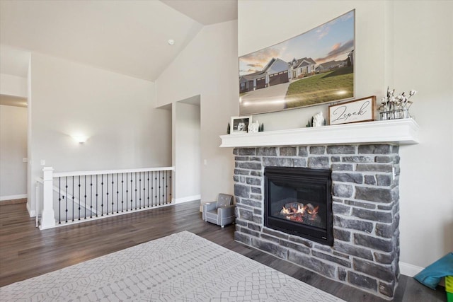 7759 Sunstone Ct, De Pere, WI 54115 - living room featuring wood finished floors, a stone fireplace, baseboards, and high vaulted ceiling