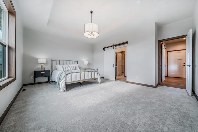 unfurnished bedroom with carpet and a barn door