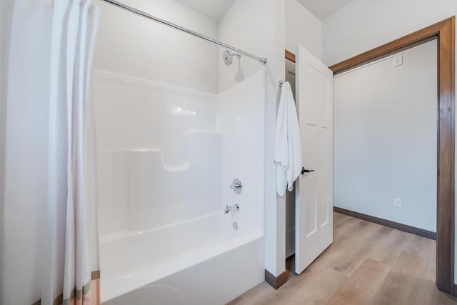 bathroom featuring hardwood / wood-style floors and shower / washtub combination