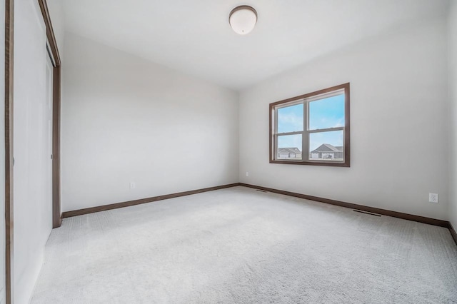 unfurnished bedroom with a closet and light carpet