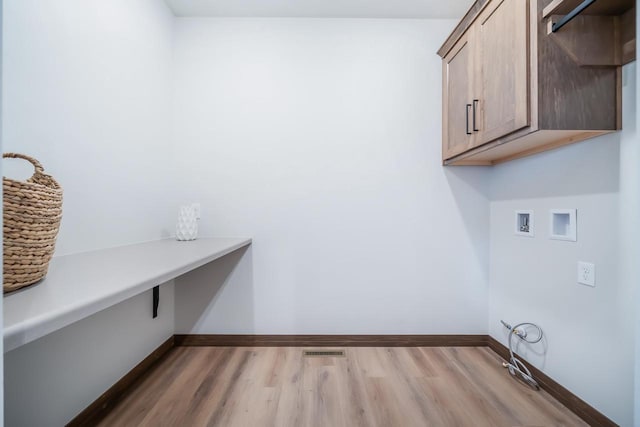 laundry area featuring light hardwood / wood-style flooring, cabinets, and hookup for a washing machine