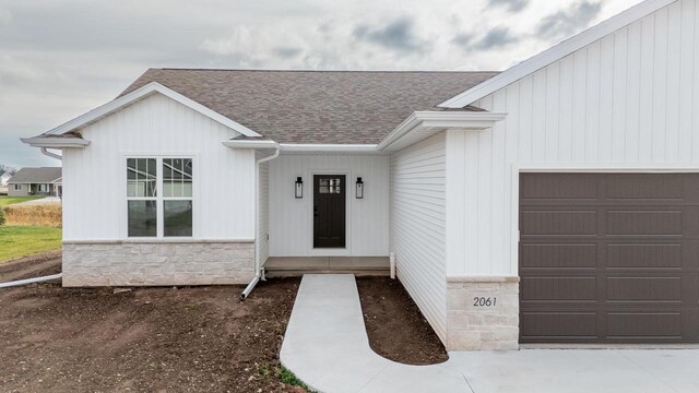 doorway to property with a garage