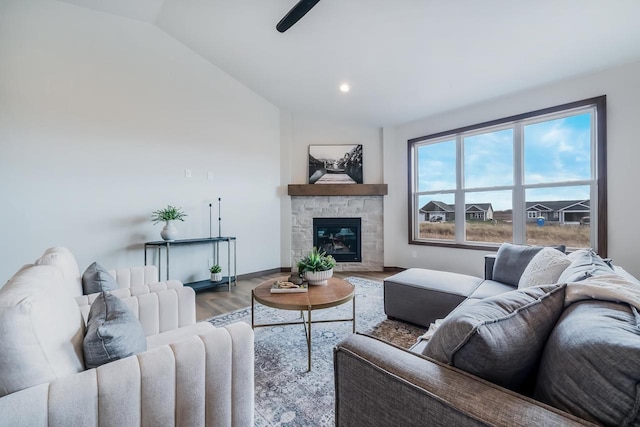 living room featuring a fireplace, wood-type flooring, and lofted ceiling