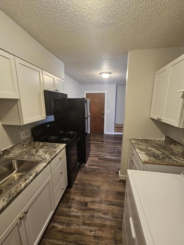 kitchen featuring black appliances, white cabinets, dark hardwood / wood-style floors, a textured ceiling, and washer / clothes dryer