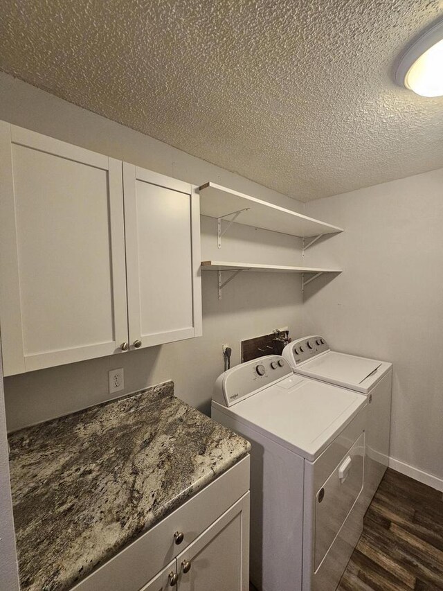 1160 Oakview Dr, Saint Charles, MN 55972 - laundry room featuring washing machine and dryer, dark wood-style floors, cabinet space, a textured ceiling, and baseboards