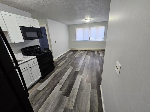 kitchen with dark hardwood / wood-style flooring, a textured ceiling, a baseboard heating unit, black appliances, and white cabinetry