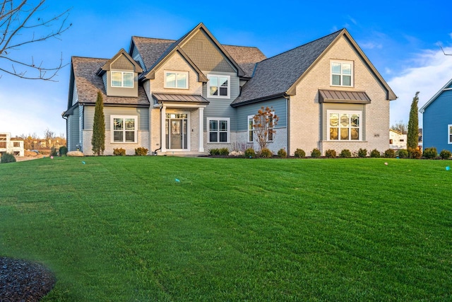 craftsman inspired home with a front lawn