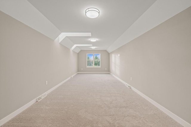 additional living space with carpet and vaulted ceiling