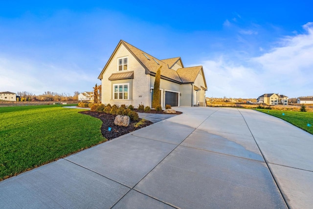 front of property with a garage and a front lawn