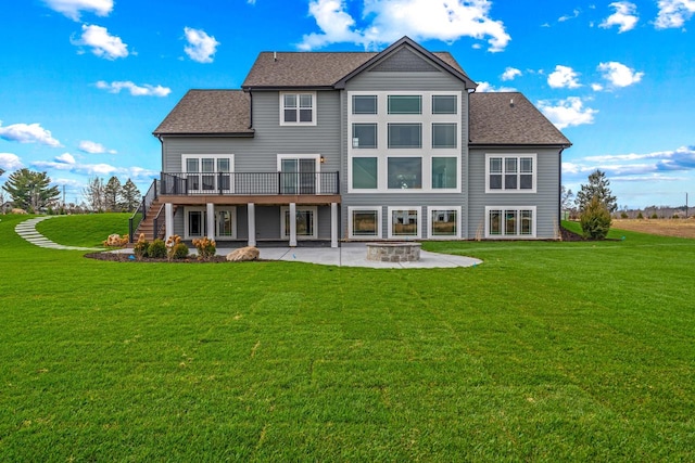 back of property with a patio area, a yard, and a deck