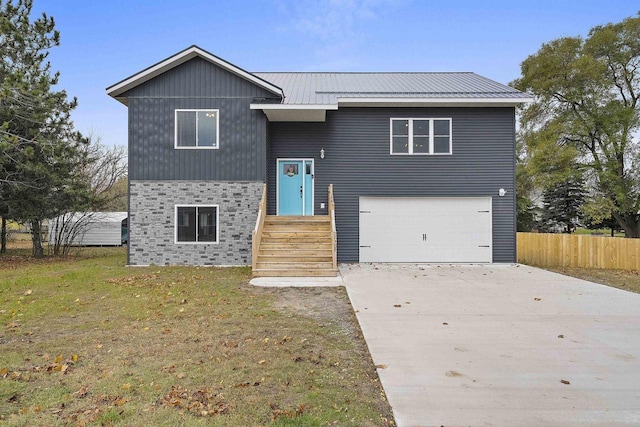 view of front facade featuring a front yard and a garage