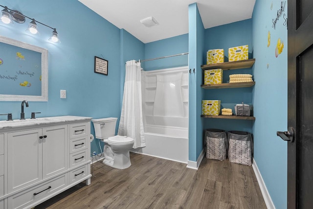 full bathroom with hardwood / wood-style floors, vanity, shower / tub combo, and toilet