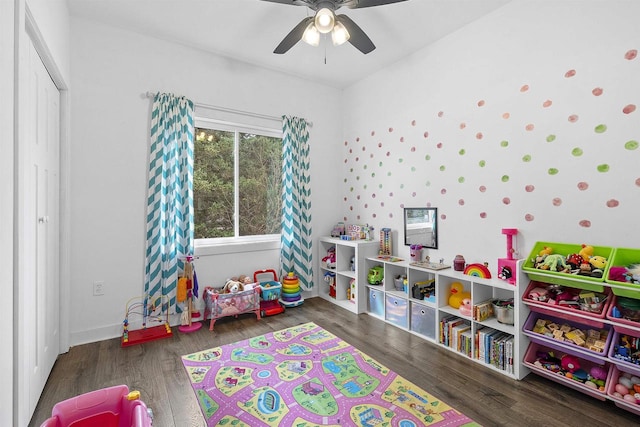 playroom with ceiling fan and dark wood-type flooring