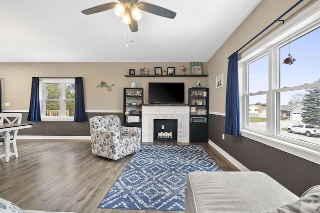 living room featuring a wealth of natural light, ceiling fan, and wood-type flooring