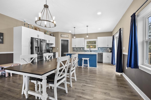 dining room featuring an inviting chandelier and hardwood / wood-style flooring