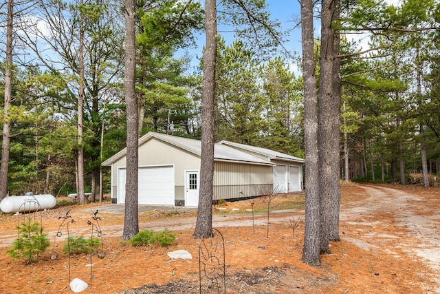 view of side of property with an outbuilding and a garage