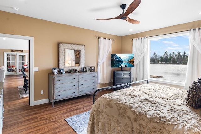 bedroom with ceiling fan and dark wood-type flooring