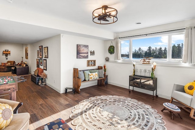 sitting room featuring a notable chandelier and dark hardwood / wood-style flooring