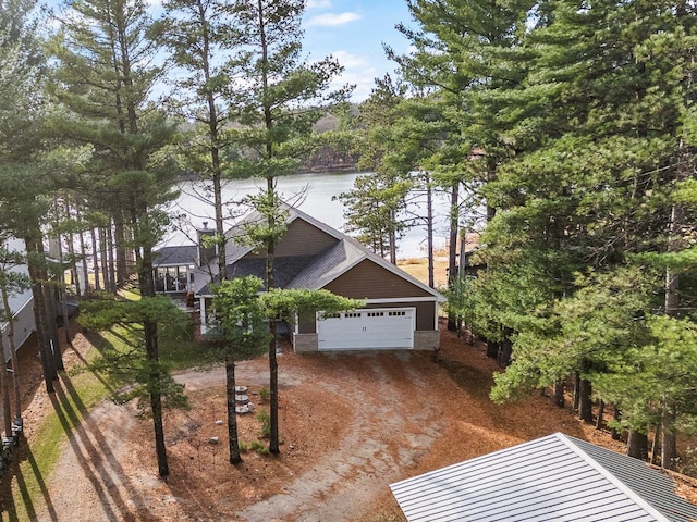 exterior space featuring a water view and a garage