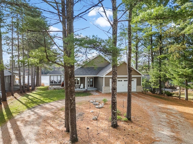 view of front of house with a front lawn, a porch, and a garage