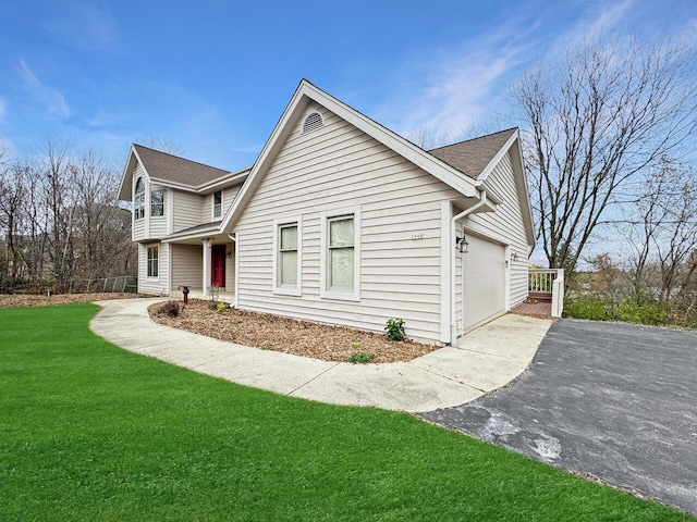 front facade featuring a front yard and a garage