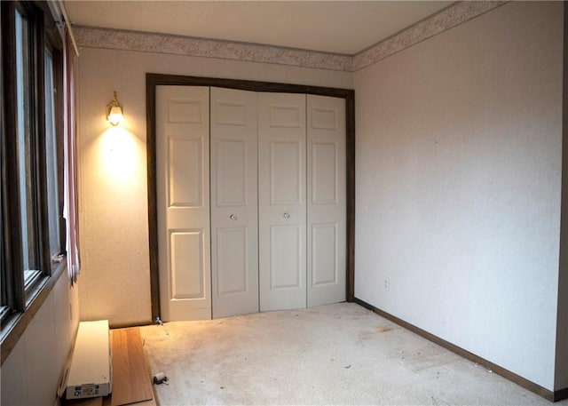 unfurnished bedroom with carpet and a closet