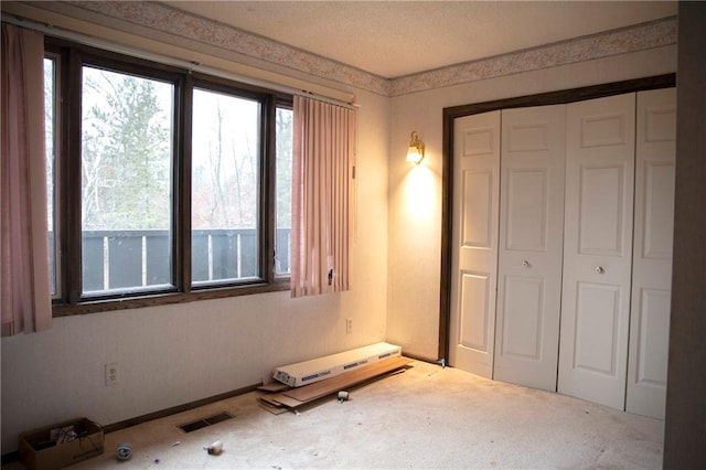 unfurnished bedroom with carpet flooring and a closet