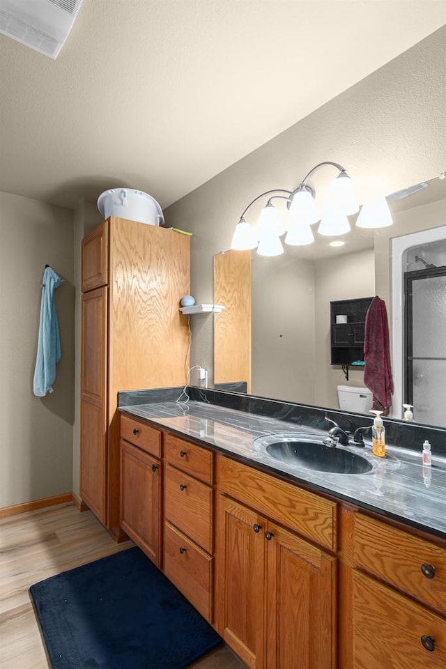 bathroom with hardwood / wood-style floors and vanity