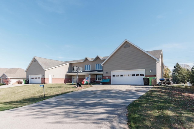 view of front of home featuring a front yard and a garage