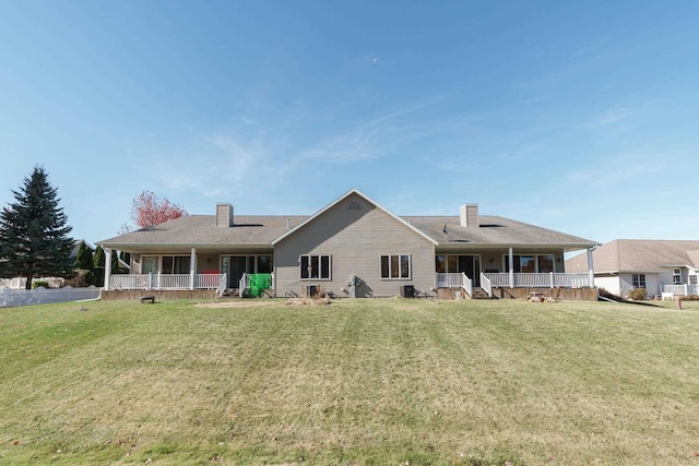 rear view of house with a lawn