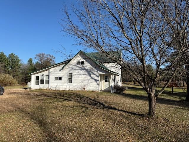 view of home's exterior with a yard