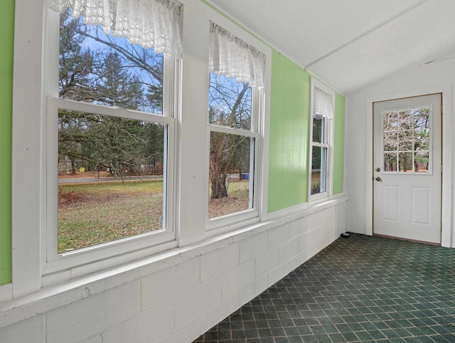 unfurnished sunroom with a wealth of natural light and vaulted ceiling