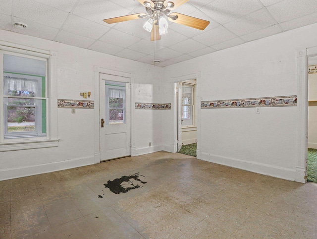 unfurnished room with a paneled ceiling and ceiling fan