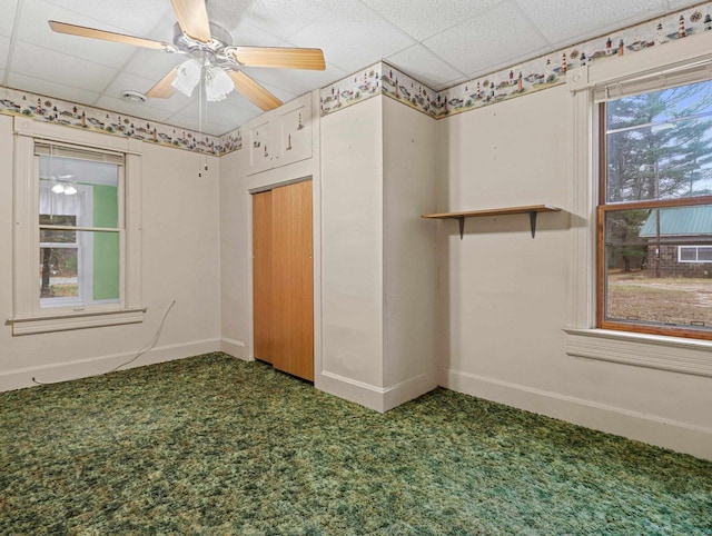 unfurnished room with a paneled ceiling and carpet