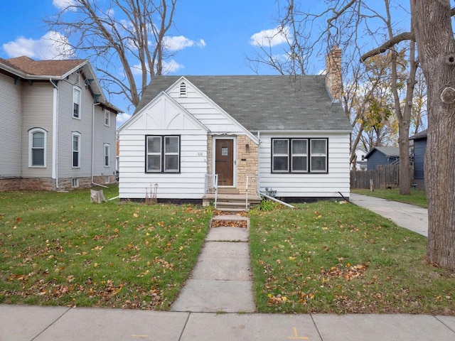 bungalow-style house with a front lawn