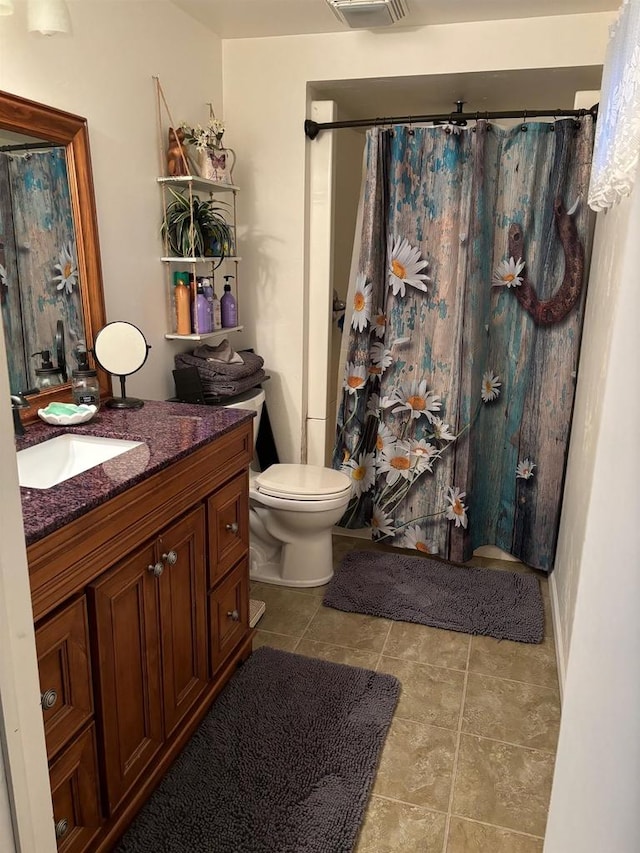 bathroom featuring toilet, tile patterned flooring, a shower with shower curtain, and vanity