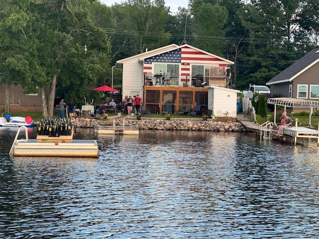 exterior space featuring a water view and fence