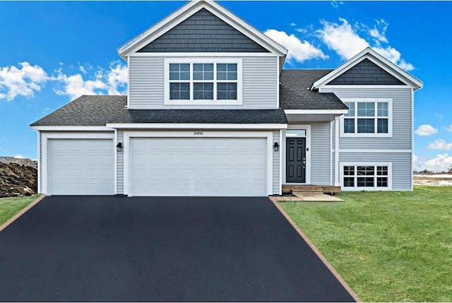 view of front of home featuring a front lawn and a garage