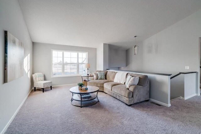 carpeted living room featuring a textured ceiling