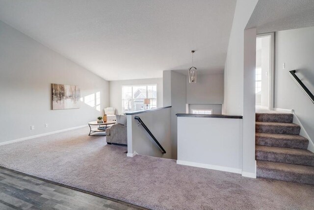 staircase with carpet and vaulted ceiling