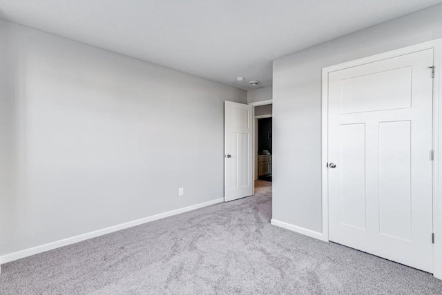 unfurnished bedroom with light colored carpet