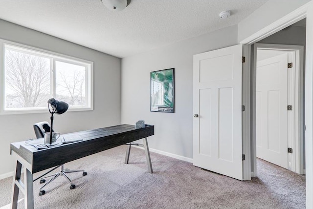 carpeted office with a textured ceiling