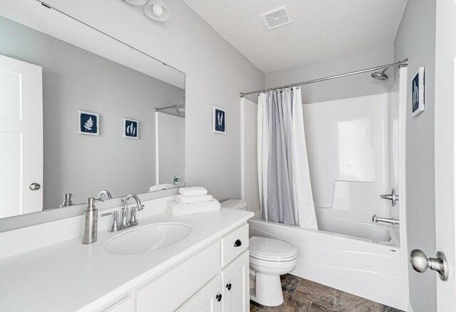 full bathroom featuring toilet, vanity, and shower / bath combo