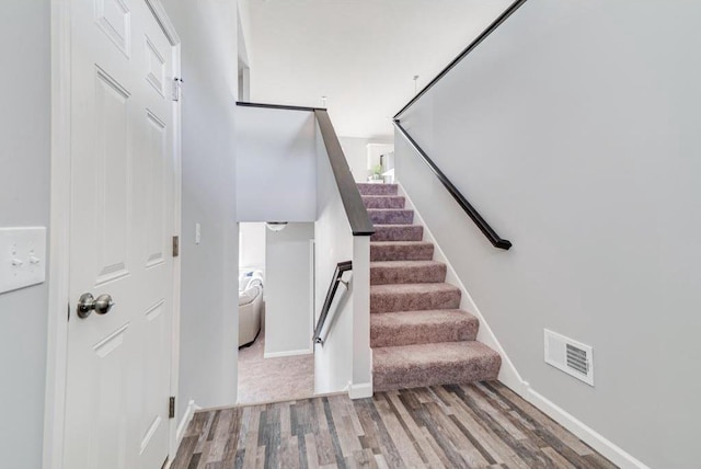 staircase featuring wood-type flooring