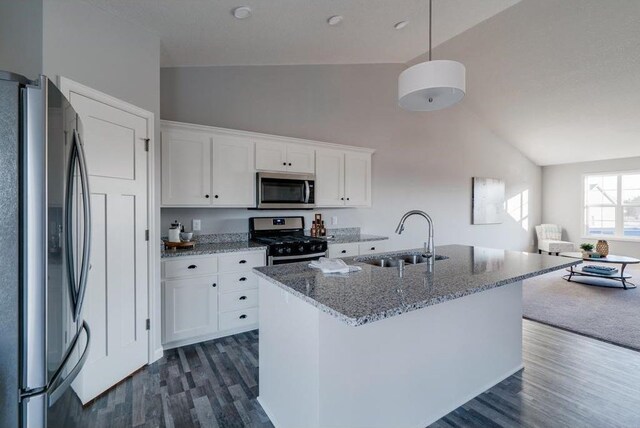 kitchen featuring pendant lighting, sink, white cabinetry, appliances with stainless steel finishes, and stone countertops